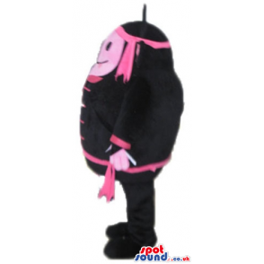 Pink monster wearing black and pink trousers, jacket and hat -