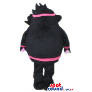 Pink monster wearing black and pink trousers, jacket and hat -