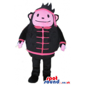 Pink monster wearing black and pink trousers, jacket and hat -