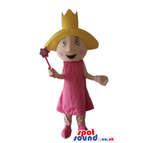 Witch wearing a pink dress and a yellow hat holding a magic