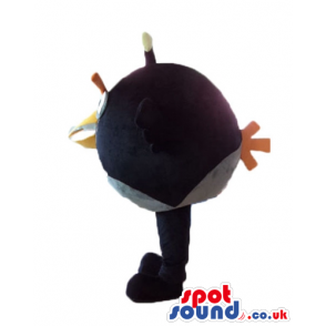 Black angry bird with thick orange eyebrows and a yellow beak -