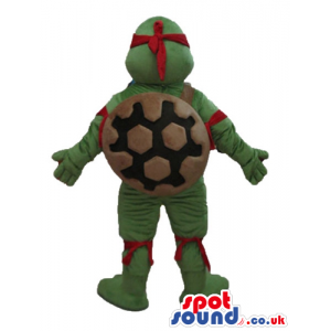 Ninja turtle with a yellow belly, a red mask round the eyes and