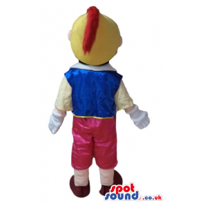 Pinnochio wearing red trousers, a yellow shirt, a blue vest, a