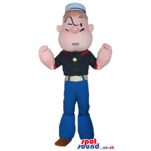 Popeye wearing a black t-shirt, blue trousers and a white sailr