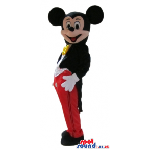 Mickey mouse wearing a black jacket red trousers, a white shirt