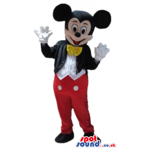 Mickey mouse wearing a black jacket red trousers, a white shirt