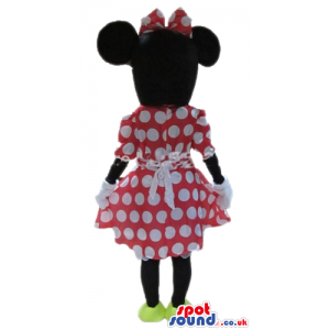 Minnie mouse wearing a red and white dress, a matching bow and