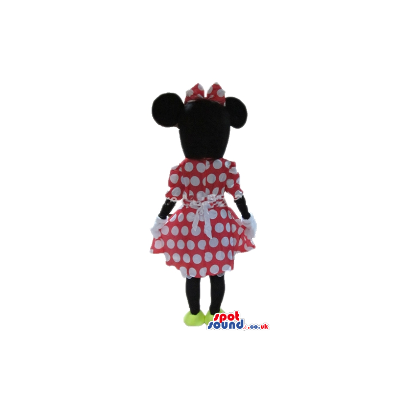 Minnie mouse wearing a red and white dress, a matching bow and