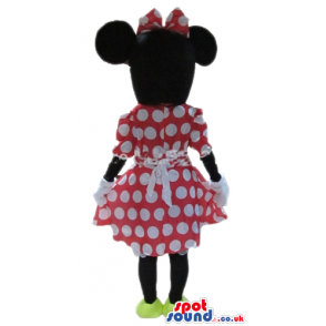 Minnie mouse wearing a red and white dress, a matching bow and