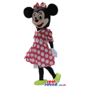Minnie mouse wearing a red and white dress, a matching bow and