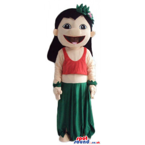 Girl with long black hair wearing a long green dress and a red