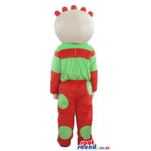 Boy wearing a red and green sweater and matching trousers -