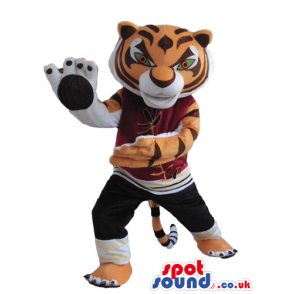 Sporty tiger wearing black trousers and a bordeaux sweater -