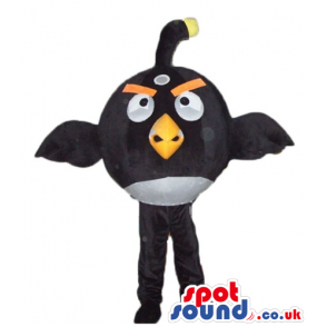 Black angry bird with thick orange eyebrows and a yellow beak -