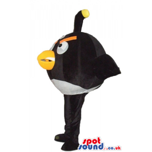 Black angry bird with thick orange eyebrows and a yellow beak -