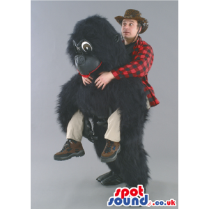 Black Gorilla Mascot With Human Walker On Top And Big Eyes -