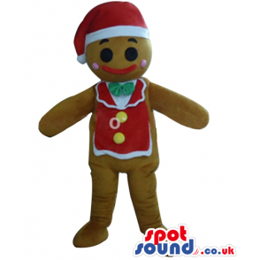 Ginger bread man wearing a santa claus hat and a red vest with