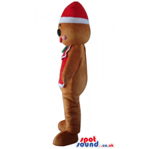 Ginger bread man wearing a santa claus hat and a red vest with