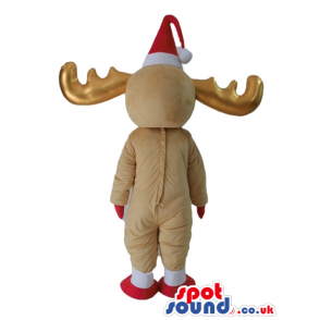 Beige deer with golden horns wearing a red santa's hat and a