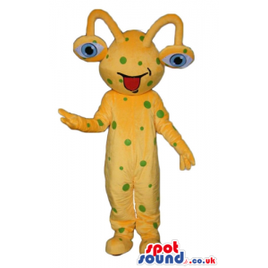Yellow monster with green dots with big blue eyes that pop out