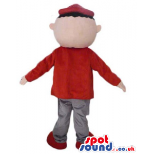 Boy wearing grey trousers, a red sweater, a red cap and red
