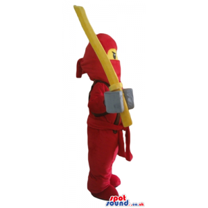 Ninja lego man wearing a red suit and holding a yellow sword -