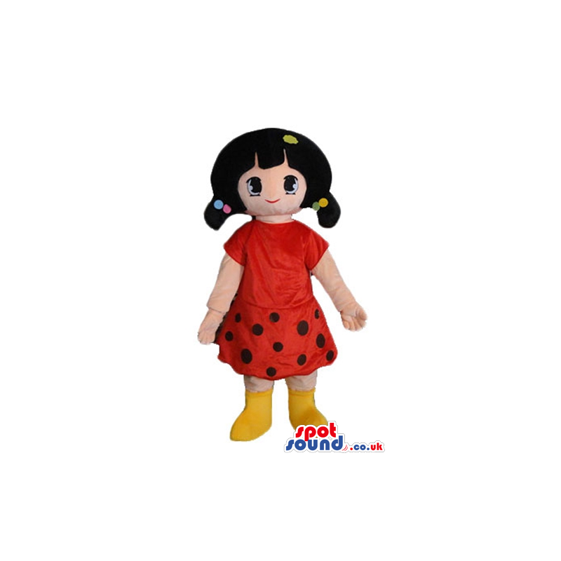 Girl with black hair wearing a red and black dress and yellow