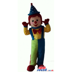 Clown with a big red nose wearing blue and green trousers, a
