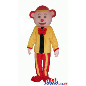 Clown with a red nose wearing a red and yellow cap, red and