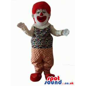 Clown with big eyes, a big red nose and curly red hair wearing