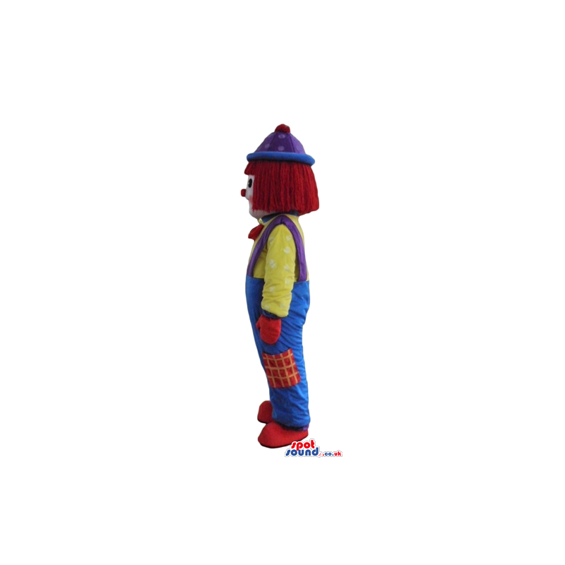 Clown with a big red nose wearing blue and green trousers, a