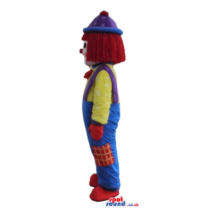 Clown with a big red nose wearing blue and green trousers, a