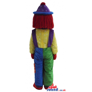 Clown with a big red nose wearing blue and green trousers, a