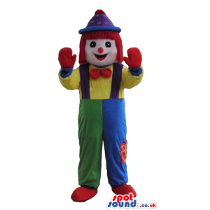 Clown with a big red nose wearing blue and green trousers, a