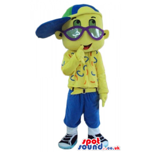 Yellow boy with big eyes and big blue glasses wearing a blue