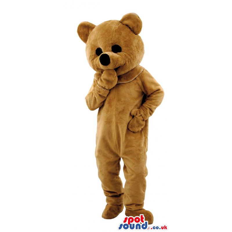 Brown teddy bear mascot thinking putting his hand in his mouth