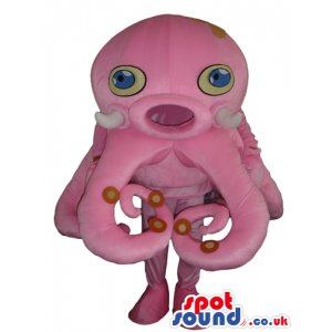 Big pink octopus with yellow and blue eyes and a round mouth -