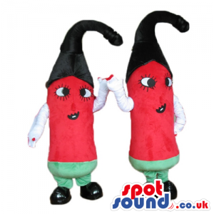 2 red peppers with big eyes, a black hat, green trousers, white