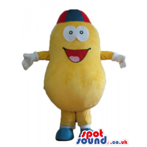 Yellow pumpkin with big round eyes wearing a red and blue cap