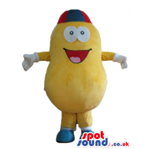 Yellow pumpkin with big round eyes wearing a red and blue cap