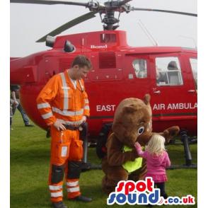 Brown teddy bear mascot thinking putting his hand in his mouth