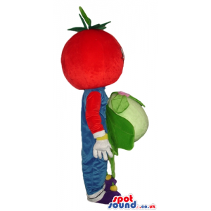 Red tomato wearing blue gardener trousers and violet shoes