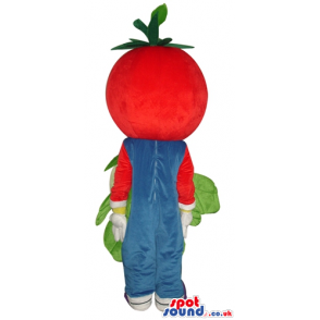 Red tomato wearing blue gardener trousers and violet shoes