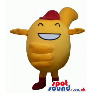 Smiling yellow monster with big eyes wearing a red hat and red