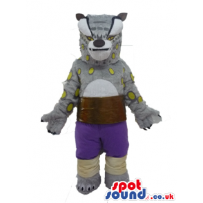 Grey hyena with yellow spots wearing violet shorts and a brown