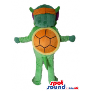 Green turtle with a yellow belly wearing an orange and purple
