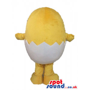 Yellow chicken with small black eyes and a huge smile hatching