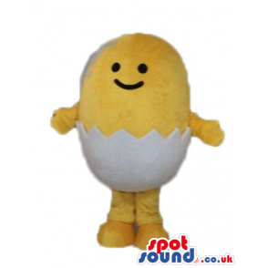 Yellow chicken with small black eyes and a huge smile hatching