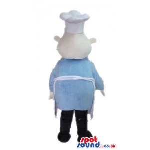 Chef wearing a white chef's hat and apron, a light-blue