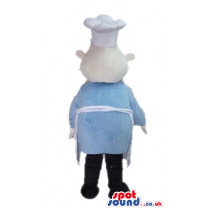 Chef wearing a white chef's hat and apron, a light-blue